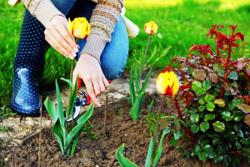 Professional gardener using safe manual handling practices